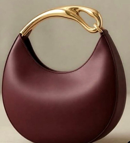 Lune Crescent bag in bordeaux smooth bio nappa with a sculptural gold handle