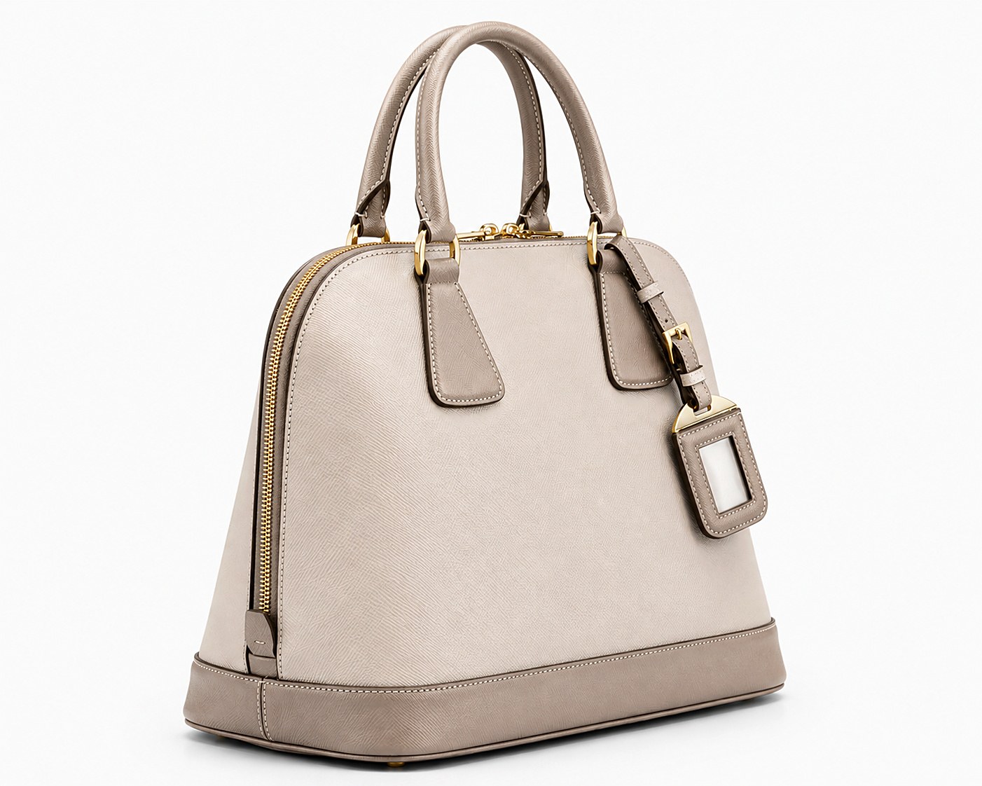 Ivoire Dome bag in saffiano-textured bio grain with a gold-tone luggage tag